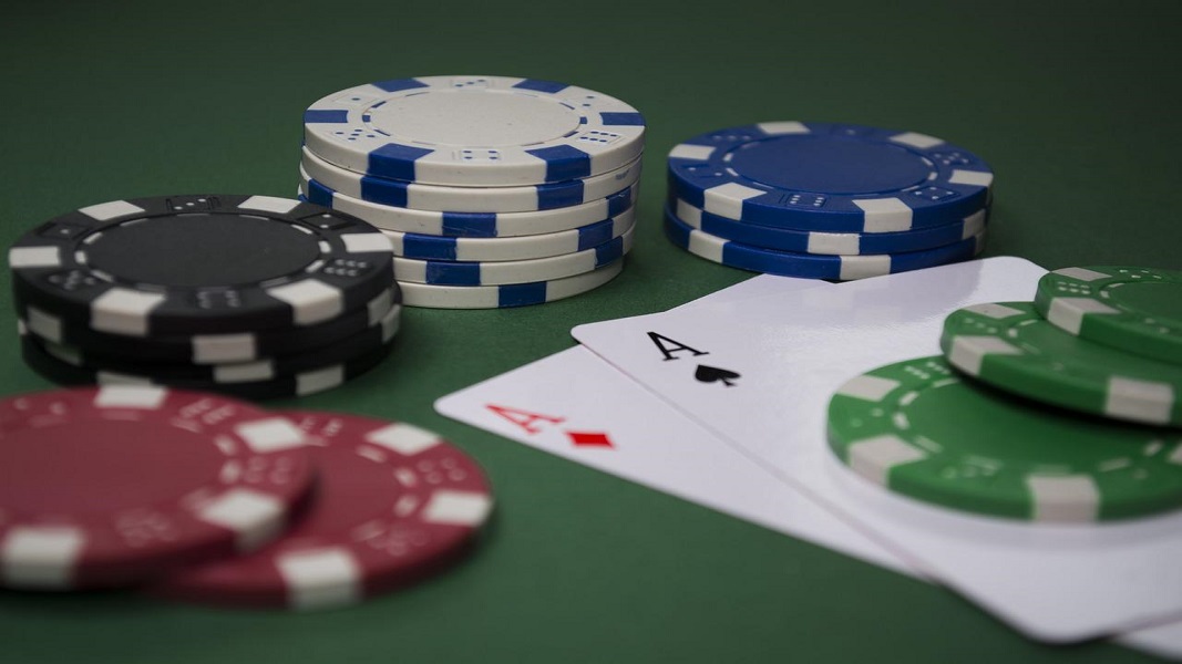 Casino chips with two Aces on casino table